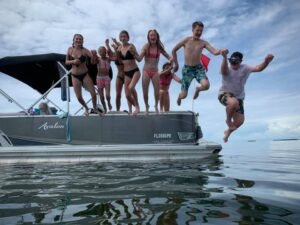 kids jumping off a boat